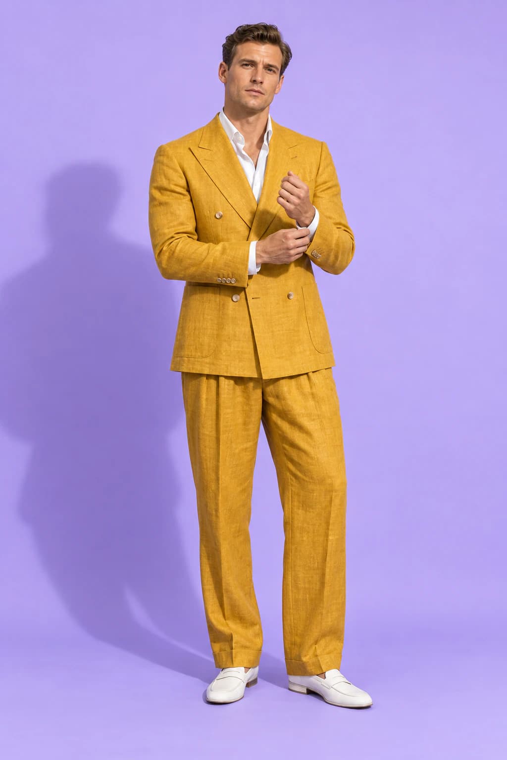 Male model in a double-breasted saffron-yellow linen suit on a lilac backdrop